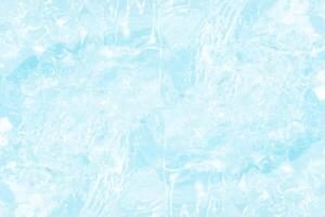 Blue water with ripples on the surface. Defocus blurred transparent blue colored clear calm water surface texture with splashes and bubbles. Water waves with shining pattern texture background. photo