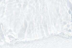 Blue water with ripples on the surface. Defocus blurred transparent blue colored clear calm water surface texture with splashes and bubbles. Water waves with shining pattern texture background. photo