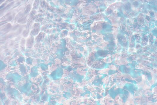 Bluewater waves on the surface ripples blurred. Defocus blurred transparent blue colored clear calm water surface texture with splash and bubbles. Water waves with shining pattern texture background. photo