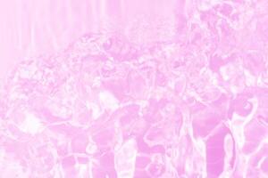 Blue water with ripples on the surface. Defocus blurred transparent blue colored clear calm water surface texture with splashes and bubbles. Water waves with shining pattern texture background. photo