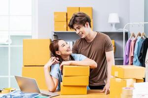 Young Asian couple business working in house office look like doing startup business and smiling happy and positive,Surprise of couple success on making big sale of his online store. photo