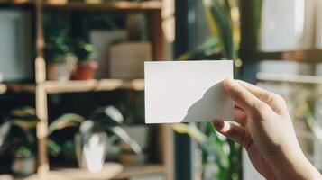 A person is holding a white card with a blank space on it photo