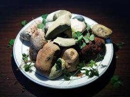 stones and leaves in a small plate placed on the table photo