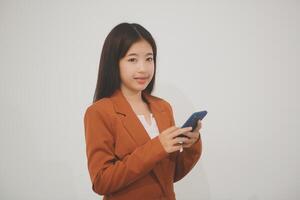 Beautiful Asian woman cute girl playing a smart phone isolated on white background - mobile phone uses a online banking for pay online shopping photo