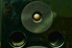 High frequency speaker tweeter in the column on dark photo