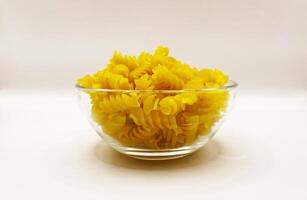 Pasta in a plate on a white background. A portion of pasta photo