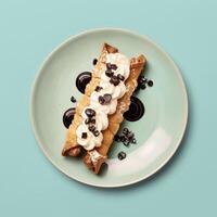 Delicious dessert of two cream filled pastry rolls topped with whipped cream, chocolate sauce and sprinkles. Sweet treat for a bakery, cafe or restaurant menu. photo