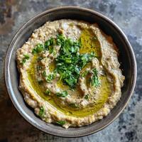 Bowl of Creamy Baba Ganoush with Parsley and Olive Oil photo