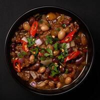 A Bowl of Hearty Chili with Red Chili Peppers photo