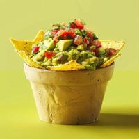 Guacamole and Chips in a Clay Pot photo