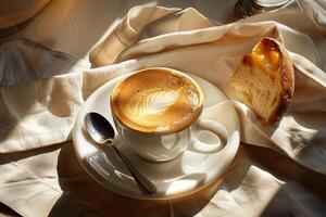 Cappuccino and Pastry on a Linen Tablecloth photo