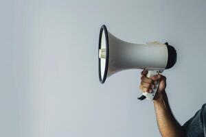 Hand holding a megaphone on a white background photo