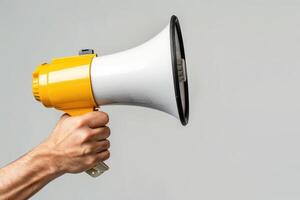 Hand holding a megaphone with a blank space for text photo