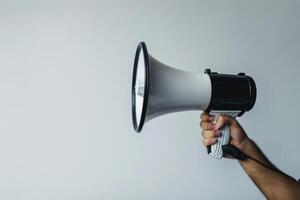 Hand holding a megaphone on a white background photo