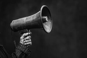 Protestor holding a megaphone to amplify message photo