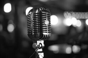 Close up of a vintage microphone on stage with blurred background lights photo