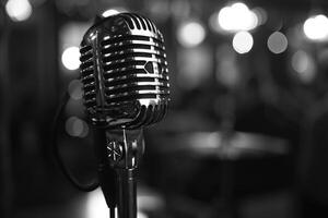Vintage microphone on stage with blurred background lights photo