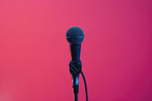 Microphone on stage with vibrant pink background photo