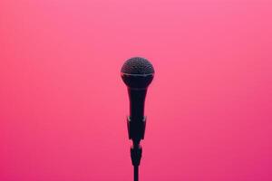 Microphone on stand with pink background photo