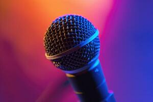 Close up of a microphone on stage with colorful blurred background lights photo