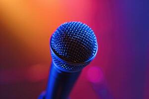 Close up of a microphone on stage with colorful blurred background lights photo