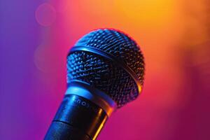 Close up of a microphone on stage with colorful blurred background lights photo