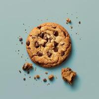 Close up of a delicious chocolate chip cookie on a light blue background. Perfect for websites, blogs and social media posts about baking, dessert, sweet, snack, food photography and more. photo