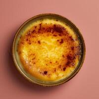 Close-up of creamy, golden-brown creme brulee with a crispy caramelized sugar topping in a ramekin. French dessert, food photography. photo