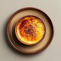 Close-up of a delicious Creme Brulee dessert with a crispy caramelized sugar topping. French cuisine, dessert, sweet, gourmet, restaurant, cafe. photo