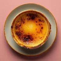 Close up of a single serving of creamy creme brulee with a perfectly caramelized top. Gourmet dessert for a romantic dinner or special occasion. photo