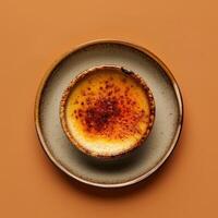 Close-up of a delicious creme brulee with a caramelized sugar crust. A classic French dessert recipe. photo