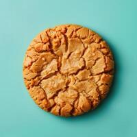 Single peanut butter cookie isolated on blue background. Close-up view of a delicious homemade peanut butter cookie. photo