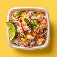 Fresh Peruvian Ceviche with lime, red onion, corn, cilantro and aji amarillo in a white bowl on a yellow background photo