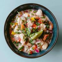 Delicious and fresh ceviche with lime, cilantro, onions, tomatoes, and fish. Peruvian seafood dish. photo