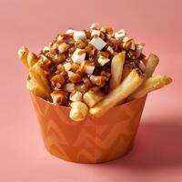 Poutine, a popular Canadian dish of french fries, cheese curds, and gravy. Close-up view of a portion of poutine in a paper cup. photo