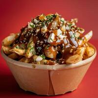 Poutine with cheese curds, gravy, and sesame seeds. Delicious and crispy fries topped with traditional Canadian ingredients. Tasty poutine in a paper bowl. photo
