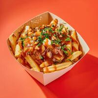 Close-up of Poutine, Canadian Dish of French Fries, Gravy and Cheese Curds in a Cardboard Container photo