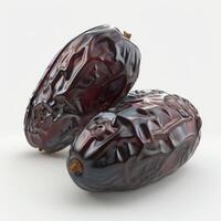 Closeup of two ripe dates with white background. Fresh dates fruit for Ramadan, Islamic holidays and healthy food. photo