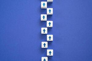 A path of arrows moving forward in a chain. Life path. The path is according to plan. photo
