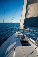 Yacht sailing in an open sea. Close-up view of the deck, mast and sails. Yachting concept. High quality photo