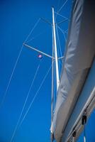 Yacht mast against a blue sky background. High quality photo