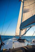 Yacht sailing in an open sea. Close-up view of the deck, mast and sails. Yachting concept. High quality photo
