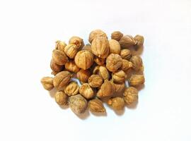 Dried cardamom, as a complementary spice in cooking seasonings, flat lay shot and isolated on white background. photo
