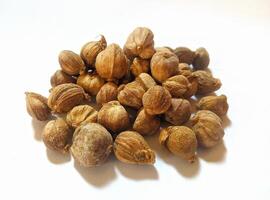 Dried cardamom, as a complementary spice in cooking seasonings, flat lay shot and isolated on white background. photo