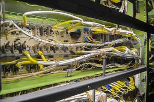 Colorful cables connected to server at data center. Colored cables intertwined with each other on the control system and server. photo