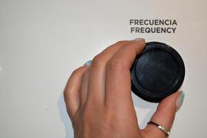 Close-up of a woman's hand holding a frequency control lever. photo