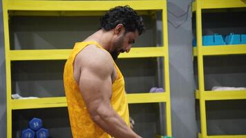 Bodybuilder Standing In The Gym And Flexing Muscles photo