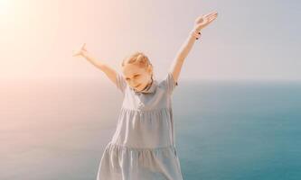 Joyful Girl with Arms Outstretched in Summer photo
