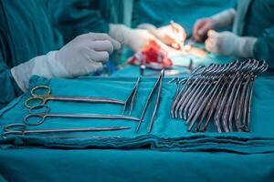 Group of Surgical Instruments used in surgical operation in operating room. An operating room may be designed and equipped to provide care to patients. photo