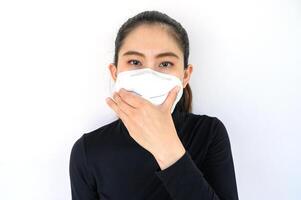 Portrait of young Asian woman wearing N95 mask for protect smog PM2.5 bad air pollution. Air pollution has been associated with diseases of the heart and lungs, cancers and other health problems. photo
